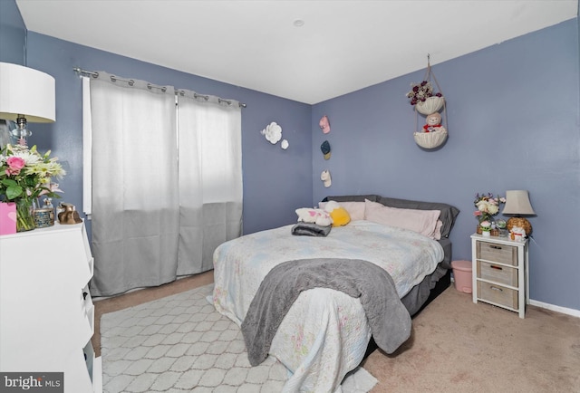 bedroom featuring light carpet