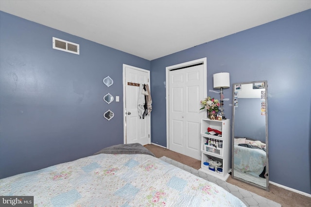 bedroom featuring light colored carpet and a closet