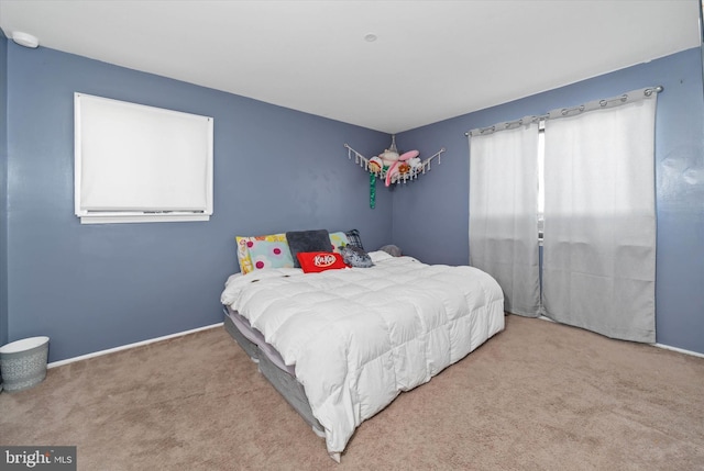 bedroom featuring light colored carpet