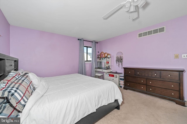 bedroom with ceiling fan and light carpet