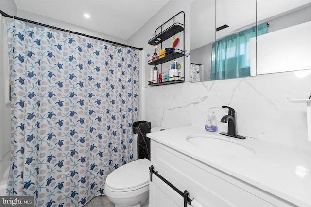 bathroom featuring toilet, walk in shower, vanity, tile walls, and tasteful backsplash