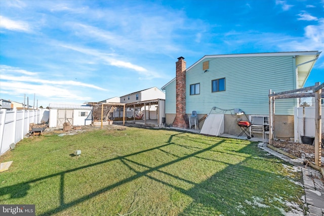 back of house with a lawn and a pergola