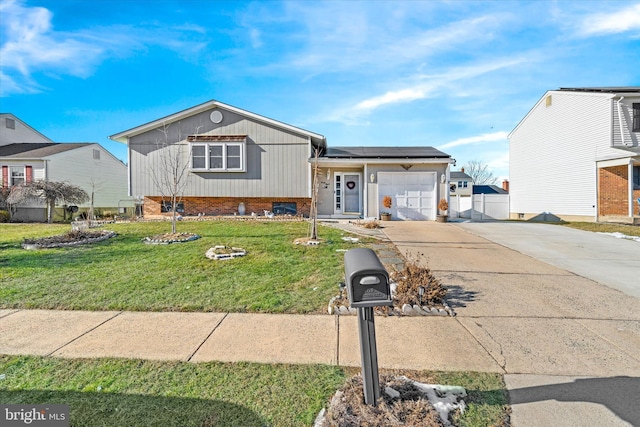 view of front of house featuring solar panels, a front lawn, and a garage