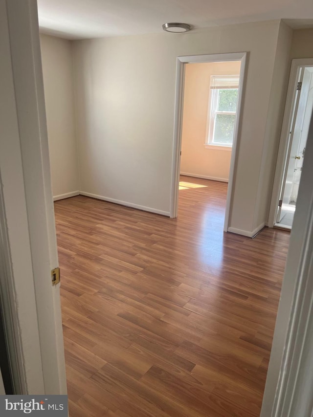 spare room featuring dark wood-type flooring