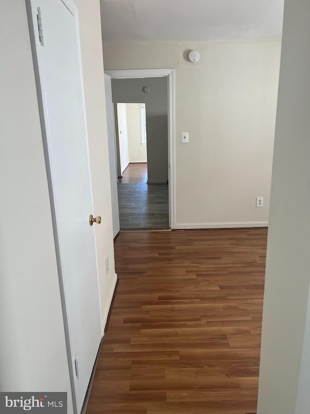 corridor featuring dark hardwood / wood-style flooring