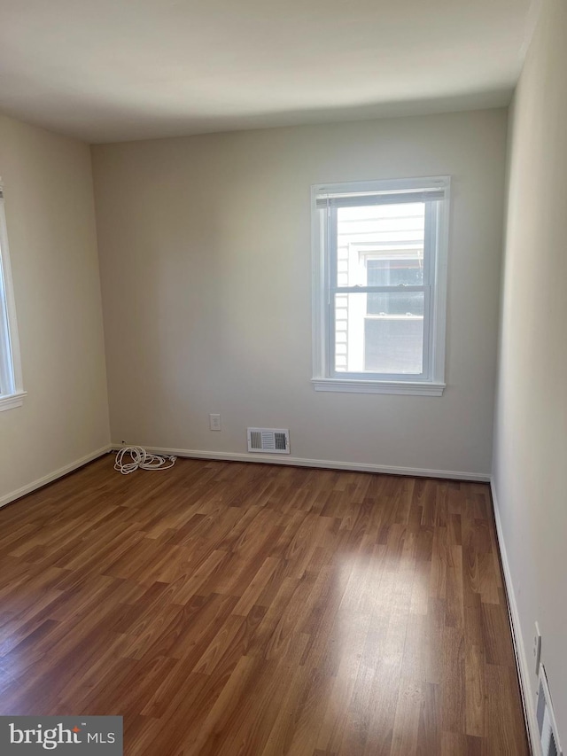 empty room featuring dark wood-type flooring