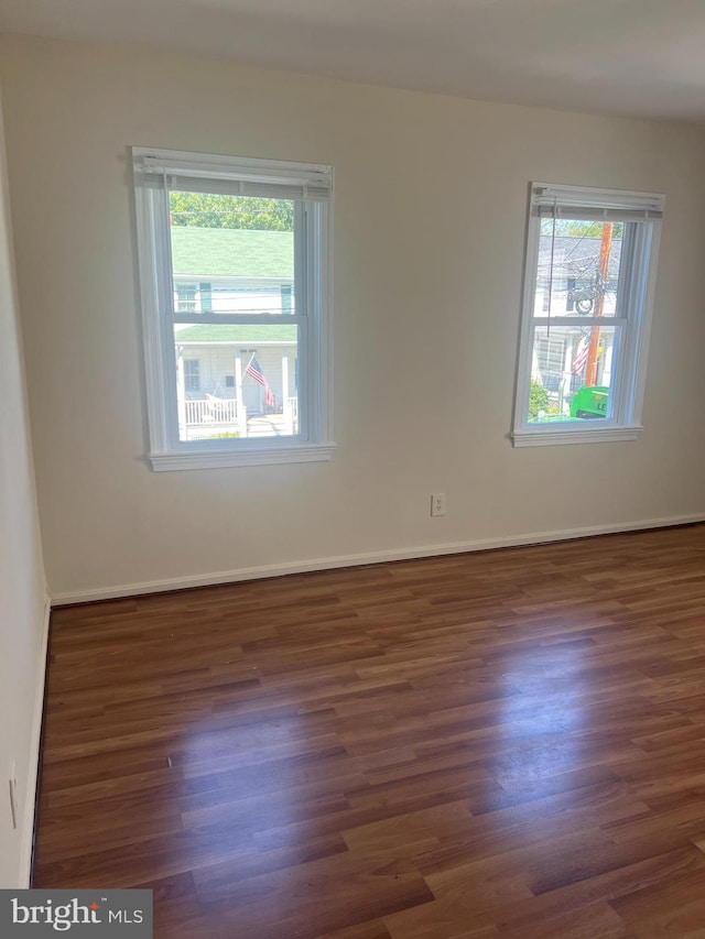 spare room featuring dark wood-type flooring