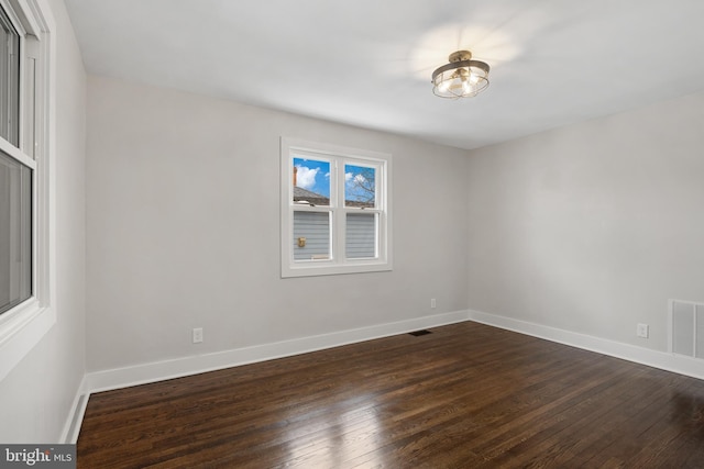 unfurnished room featuring dark wood-type flooring