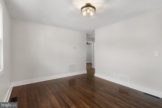 spare room featuring dark hardwood / wood-style floors