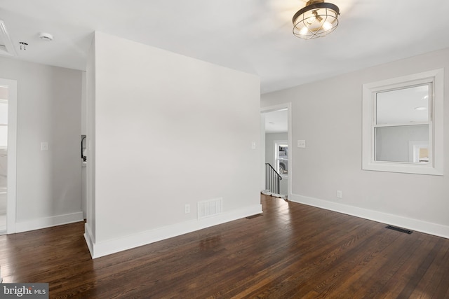 unfurnished room featuring dark hardwood / wood-style floors