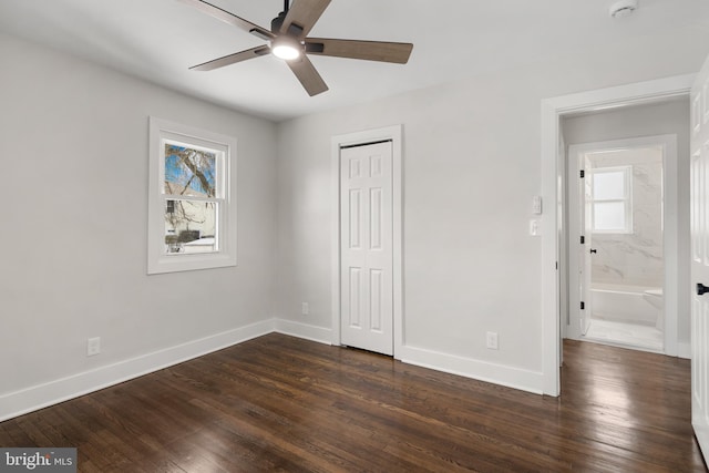 unfurnished bedroom with ceiling fan and dark wood-type flooring