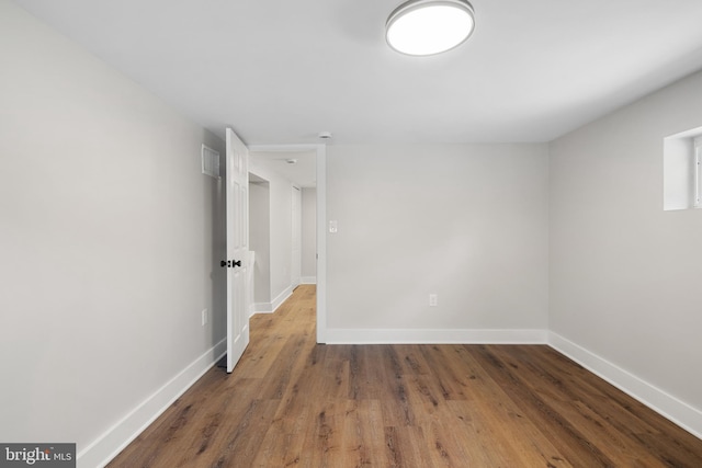 unfurnished room featuring dark hardwood / wood-style floors