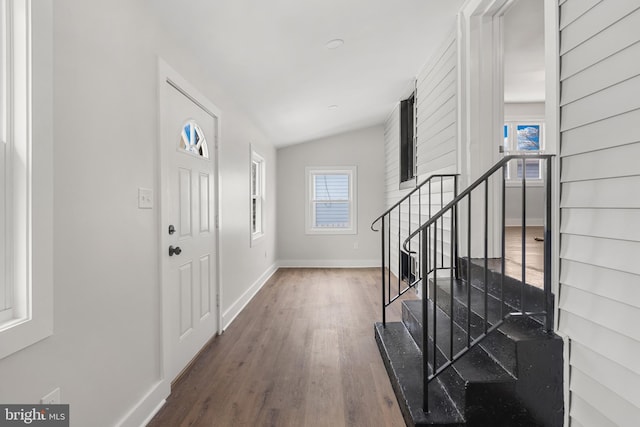 entryway featuring dark hardwood / wood-style floors and vaulted ceiling