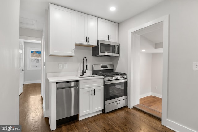 kitchen with white cabinets and appliances with stainless steel finishes