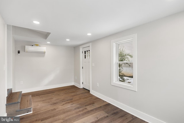 entrance foyer with dark hardwood / wood-style flooring and a wall mounted AC