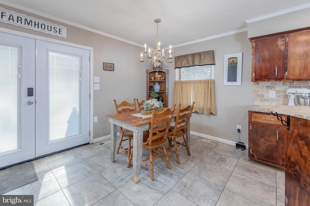 dining space featuring a chandelier and ornamental molding