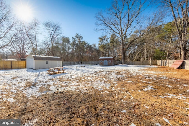 snowy yard with a storage unit