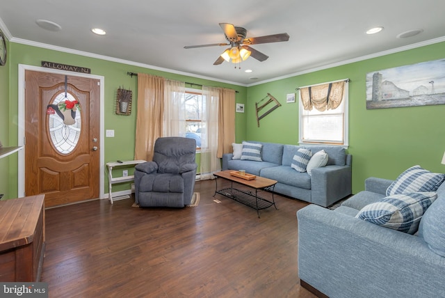 living room with dark hardwood / wood-style flooring, ceiling fan, and crown molding