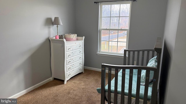 carpeted bedroom with a crib