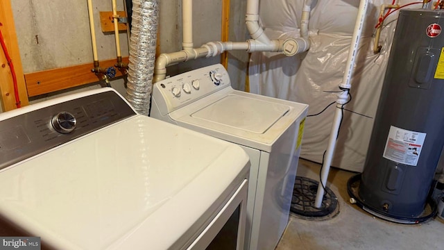 laundry area with water heater and washer and dryer