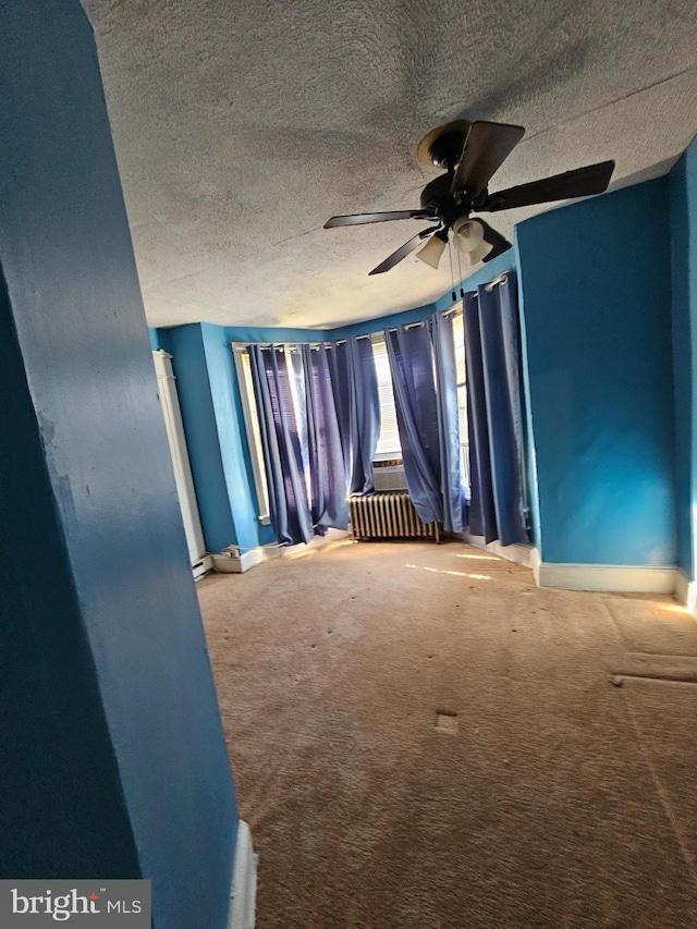 spare room featuring carpet and ceiling fan