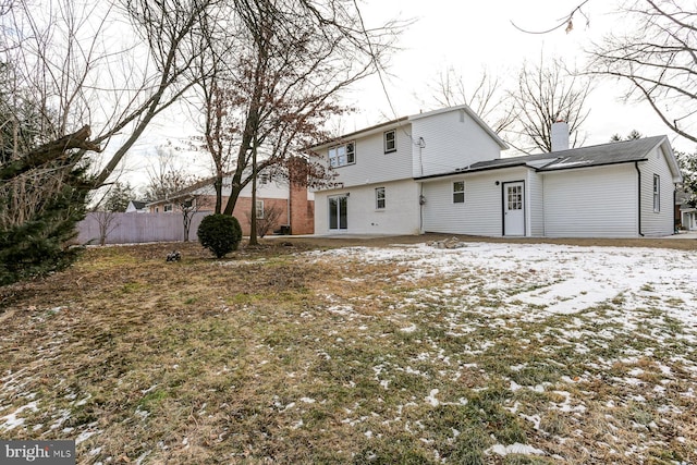 view of snow covered rear of property