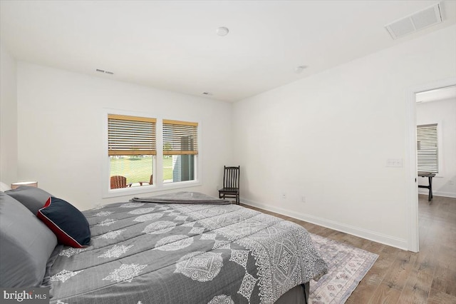 bedroom with wood-type flooring