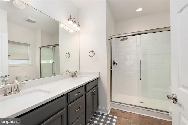 bathroom with vanity, toilet, and an enclosed shower