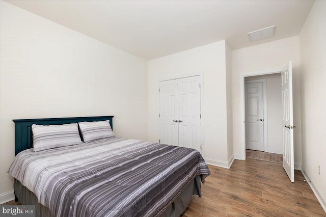 bedroom featuring a closet and wood-type flooring