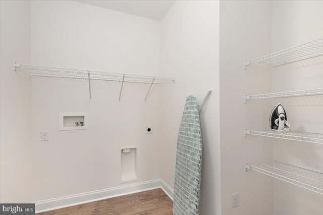 washroom featuring hookup for an electric dryer, hookup for a washing machine, and hardwood / wood-style flooring