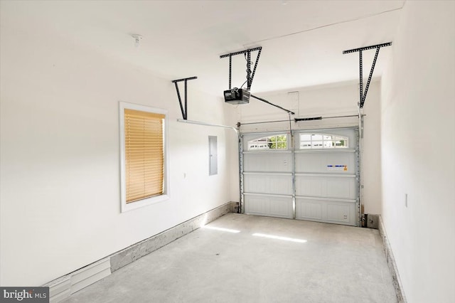 garage featuring electric panel and a garage door opener