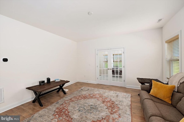 living room with light wood-type flooring and french doors