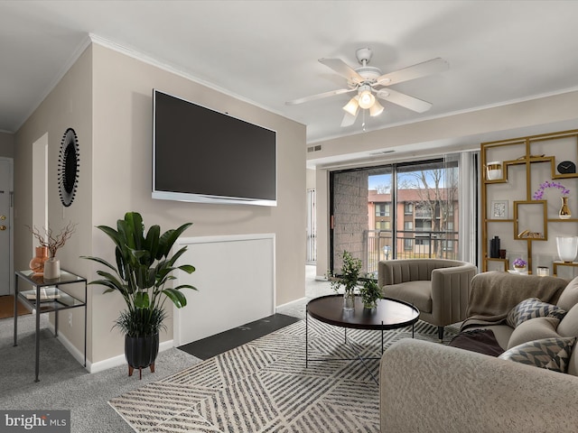 carpeted living room featuring ceiling fan and ornamental molding