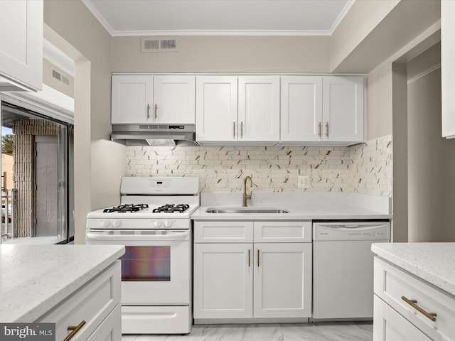 kitchen with tasteful backsplash, white cabinetry, sink, and white appliances