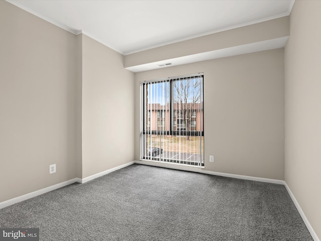 carpeted empty room featuring ornamental molding