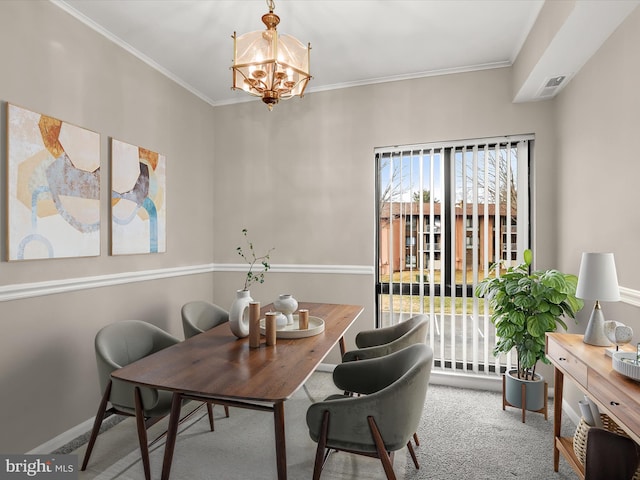 dining area featuring carpet flooring, crown molding, a wealth of natural light, and an inviting chandelier