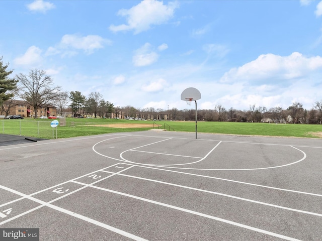 view of basketball court with a lawn