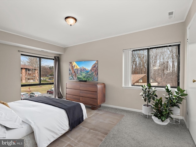 bedroom with light colored carpet and ornamental molding