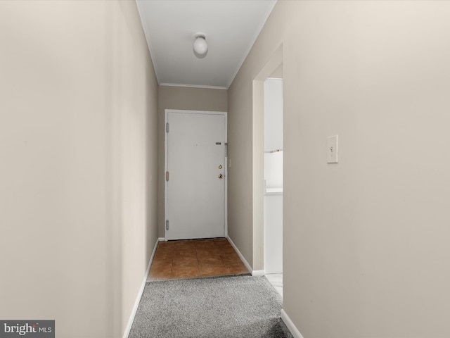 doorway to outside with carpet and ornamental molding