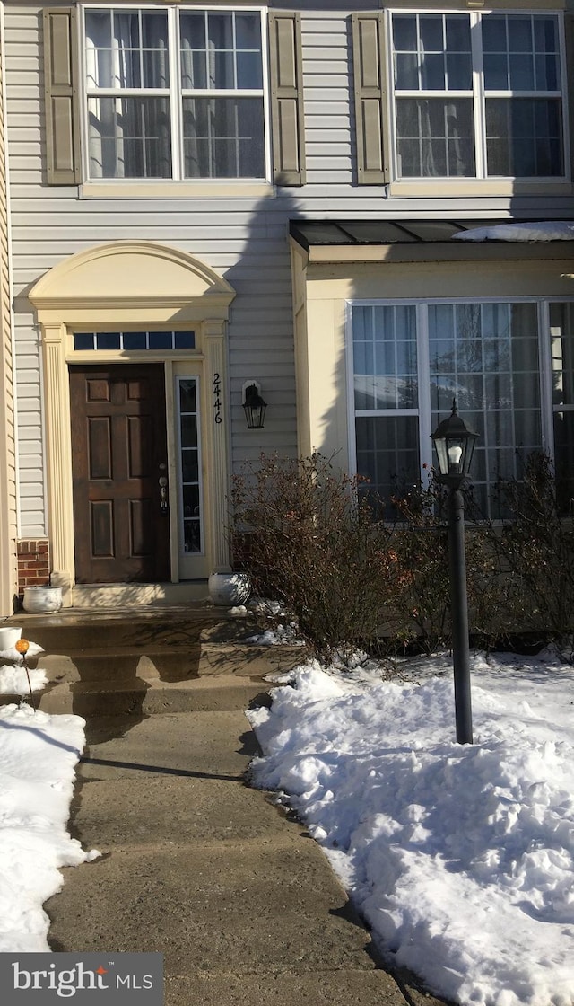 view of snow covered property entrance