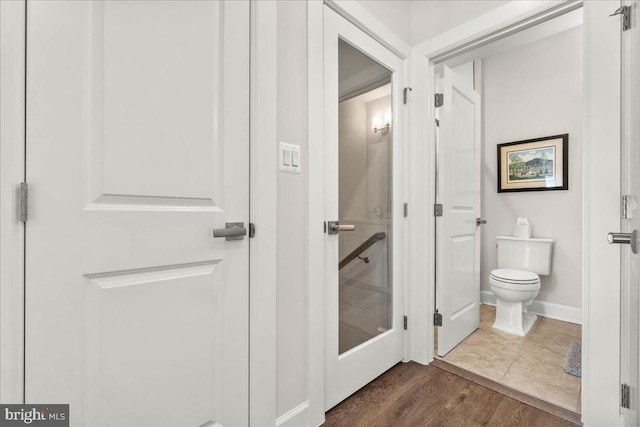 bathroom featuring hardwood / wood-style floors and toilet