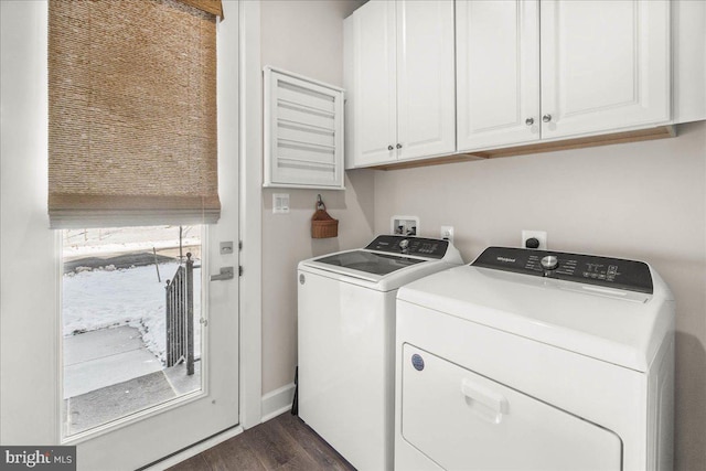 clothes washing area featuring cabinets, dark hardwood / wood-style flooring, and washing machine and clothes dryer