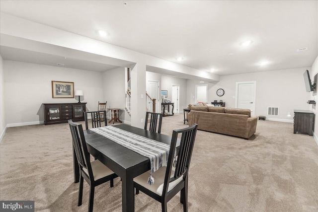 dining room with light colored carpet