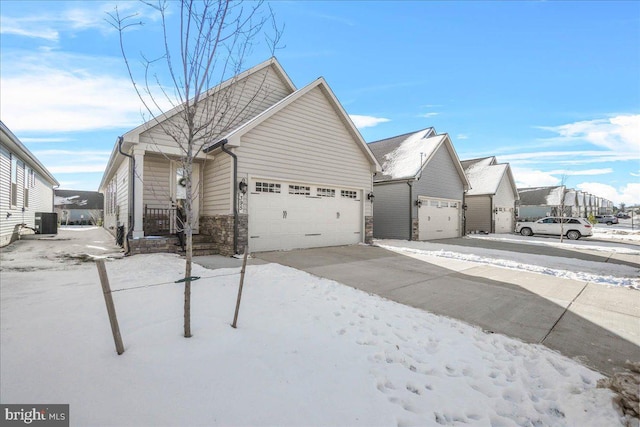 view of front of home featuring central AC unit and a garage