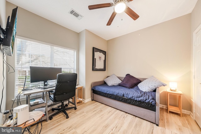 office space with ceiling fan, light hardwood / wood-style flooring, and a healthy amount of sunlight