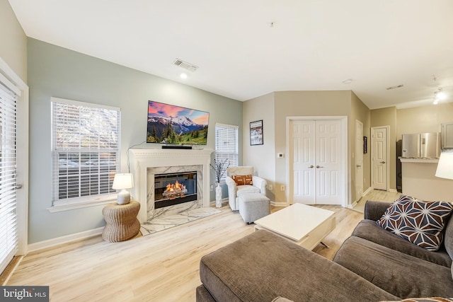 living room featuring a fireplace and light hardwood / wood-style flooring