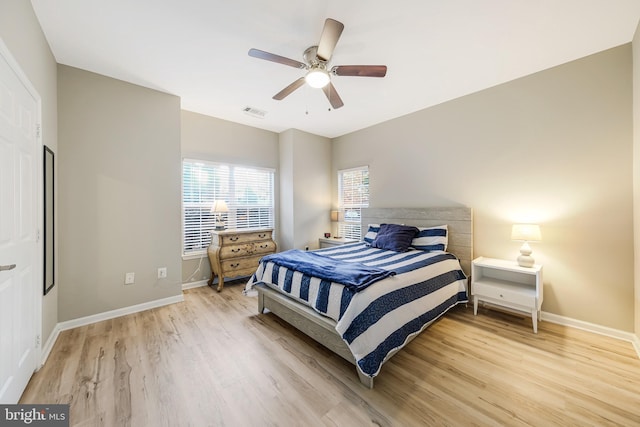 bedroom with light hardwood / wood-style floors and ceiling fan