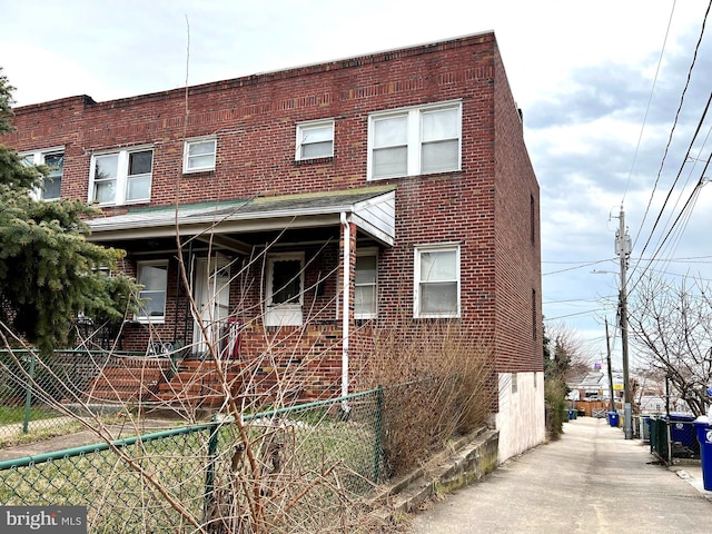 exterior space with brick siding and fence