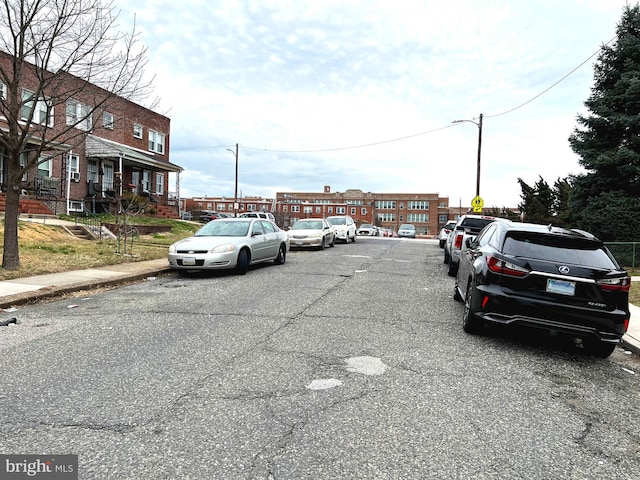 view of road featuring curbs, street lights, and sidewalks