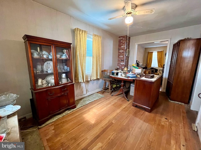 office area with wood finished floors and ceiling fan